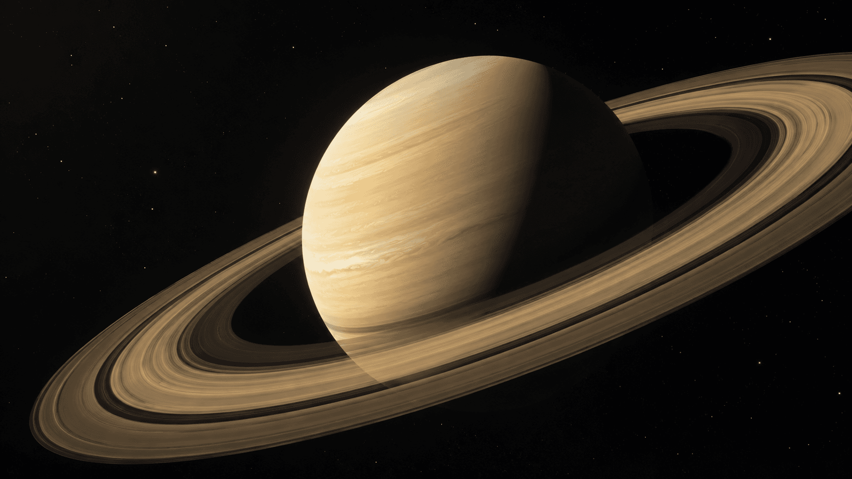 Saturn showing its pale yellow cloud bands surrounded by broad, bright icy rings